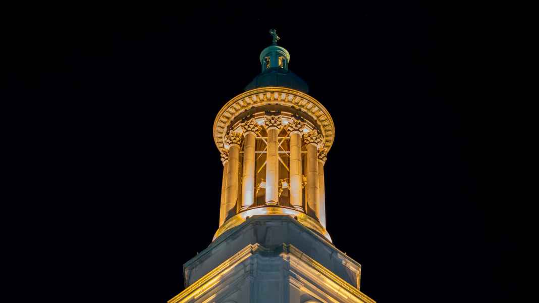 Night view of lit church columns at Saint John Baptiste in NYC