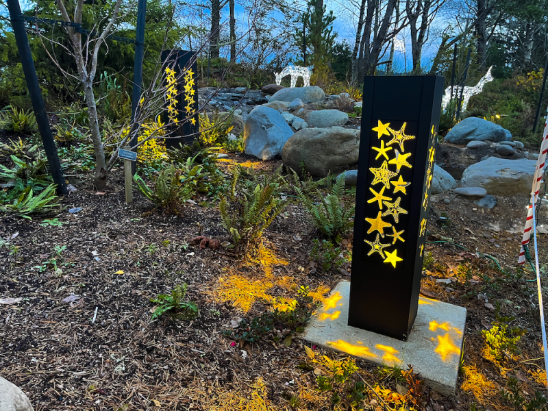 Lit Bollards With Starfish Cutouts At Dusk Outside