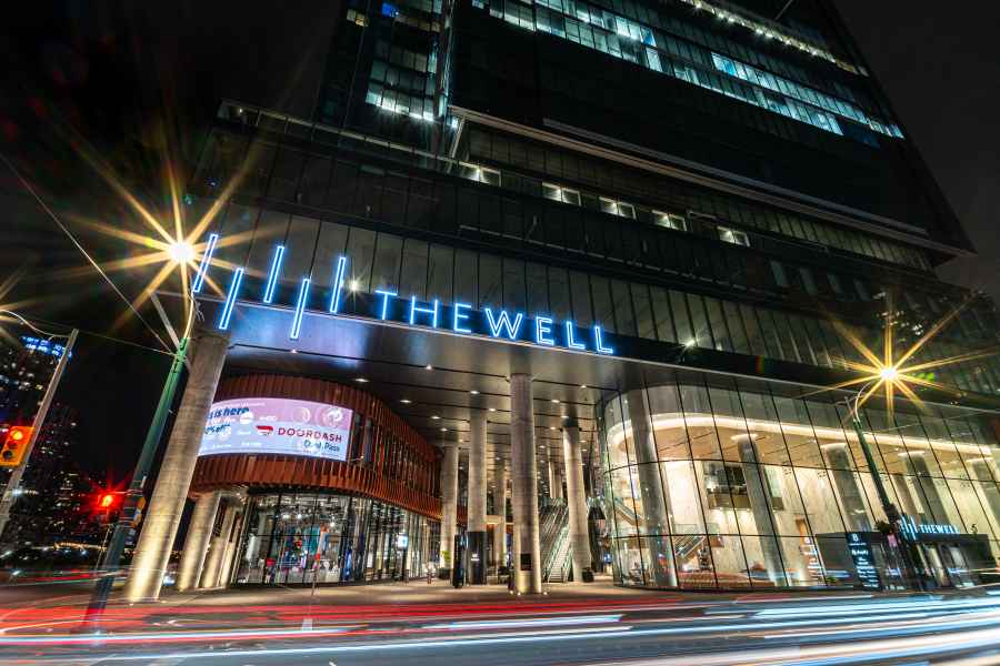 The Well Signage On Building By City Street